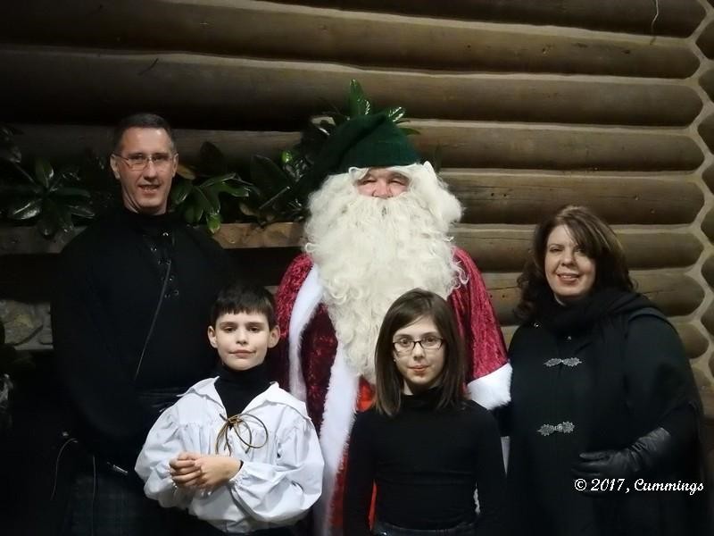 A family poses with Father Christmas